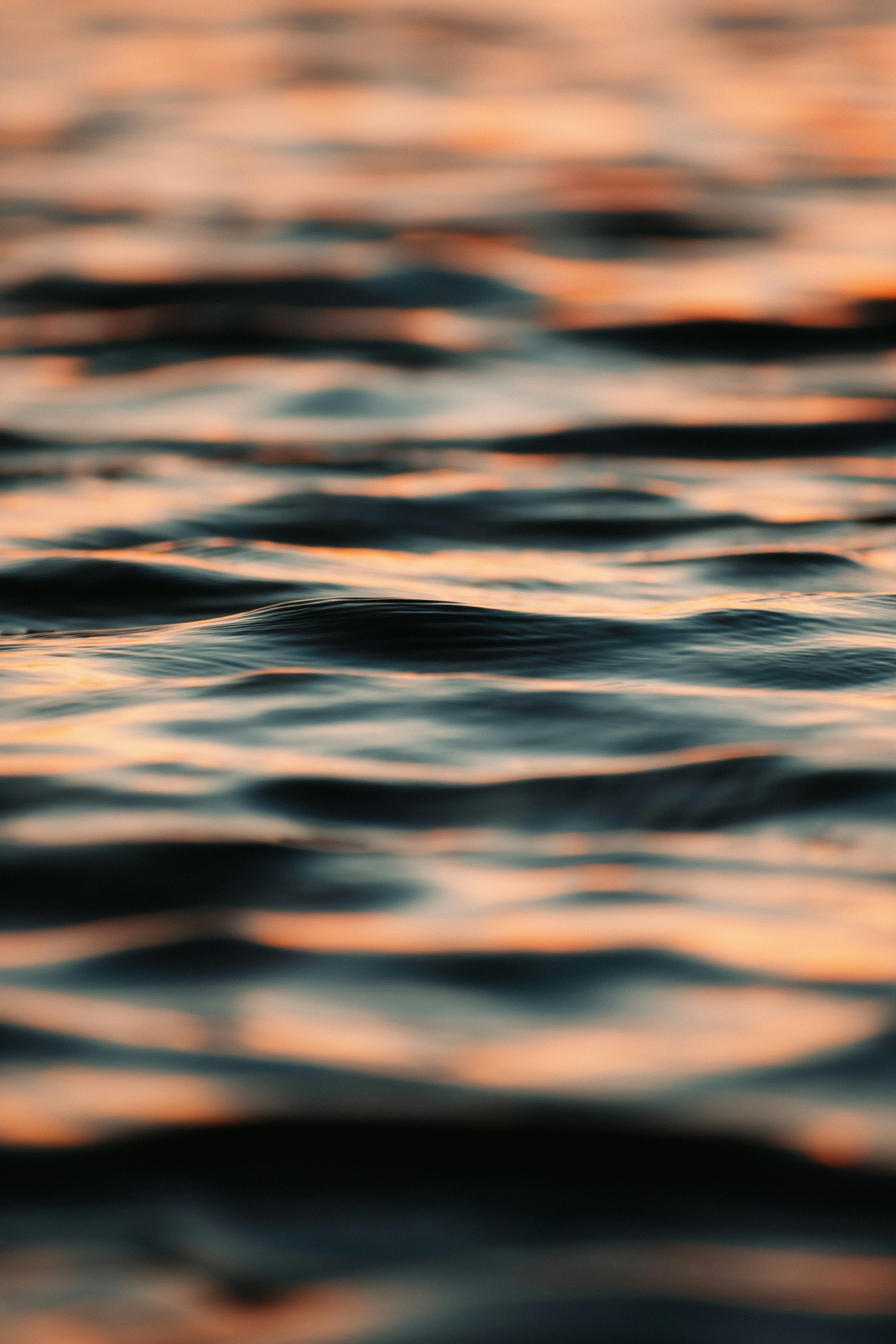 Gentle waves reflecting warm sunset light