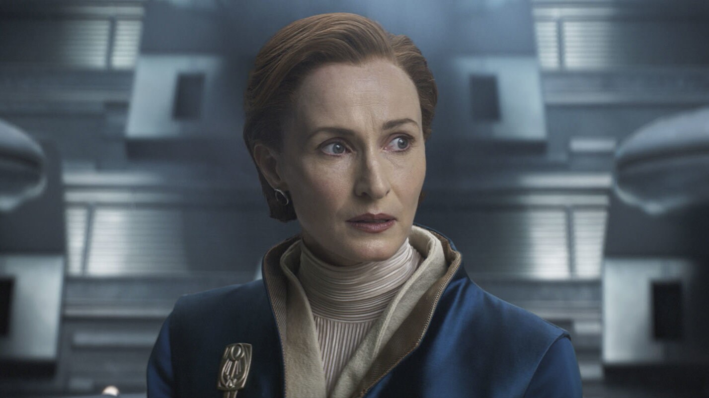 Mon Mothma in a blue and white robe looking off to the side