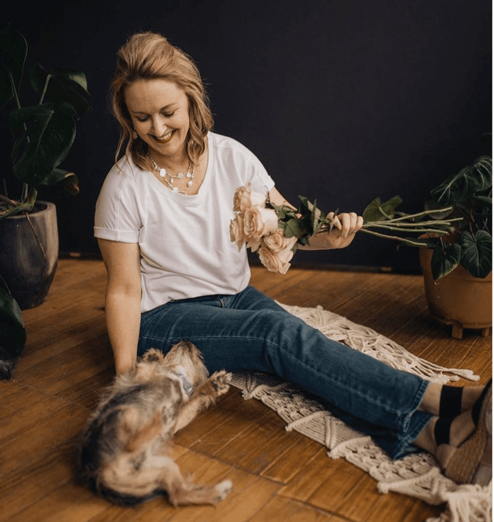 Florist Lynda with flowers and her dog in Des Moines studio.