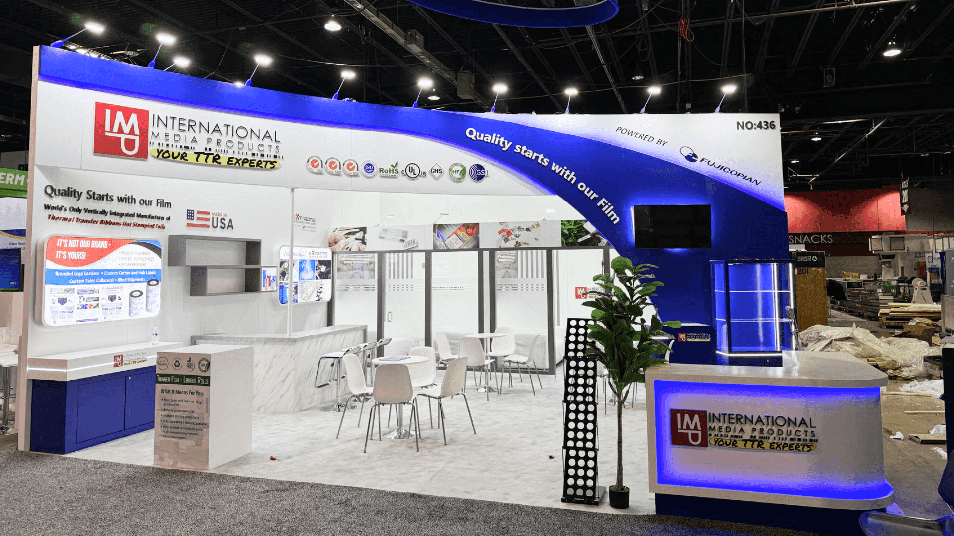 printing equipment exhibit booth with label production demo and technical display zones