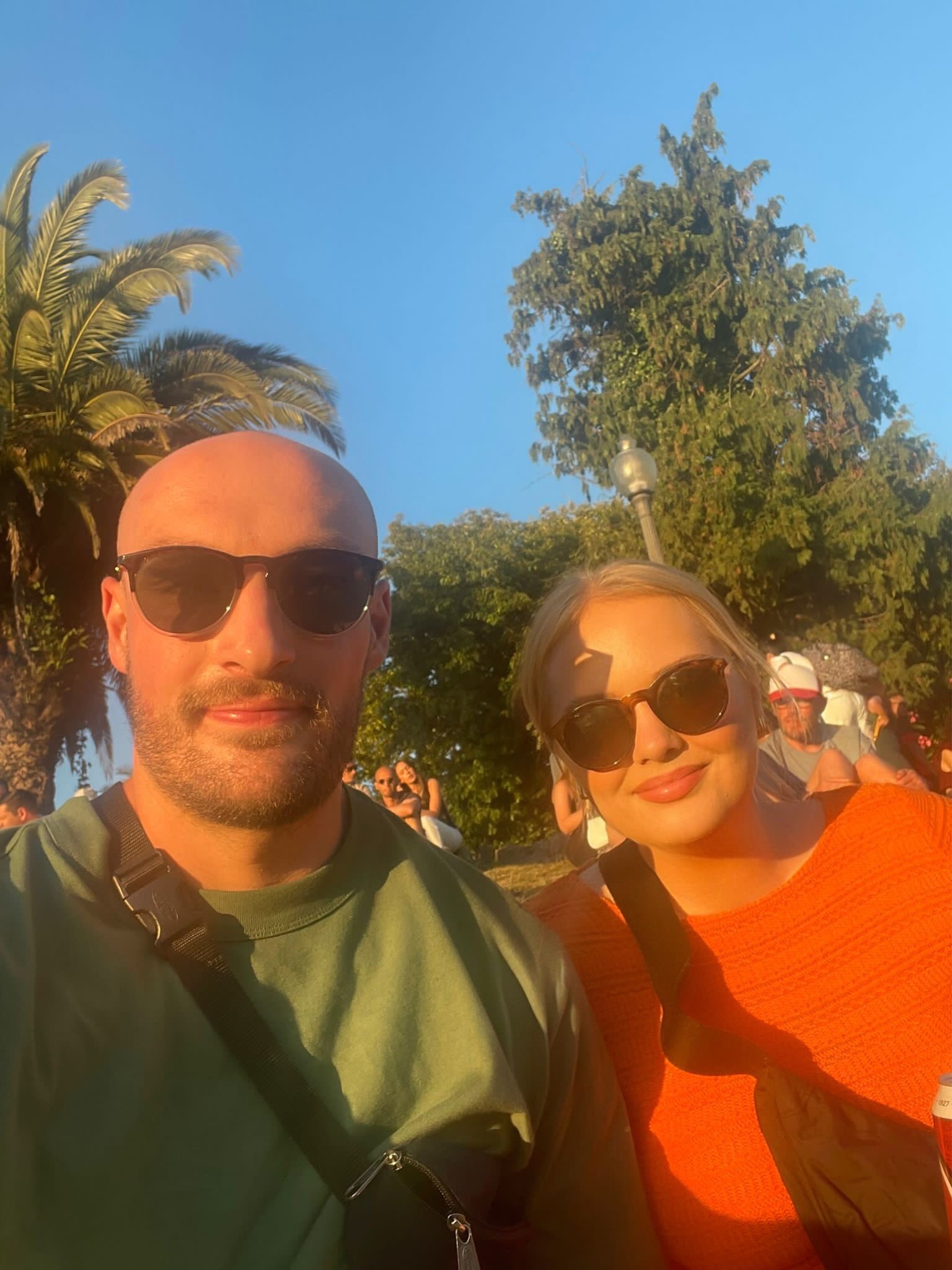 A woman in a baseball cap, blue sky in the background.