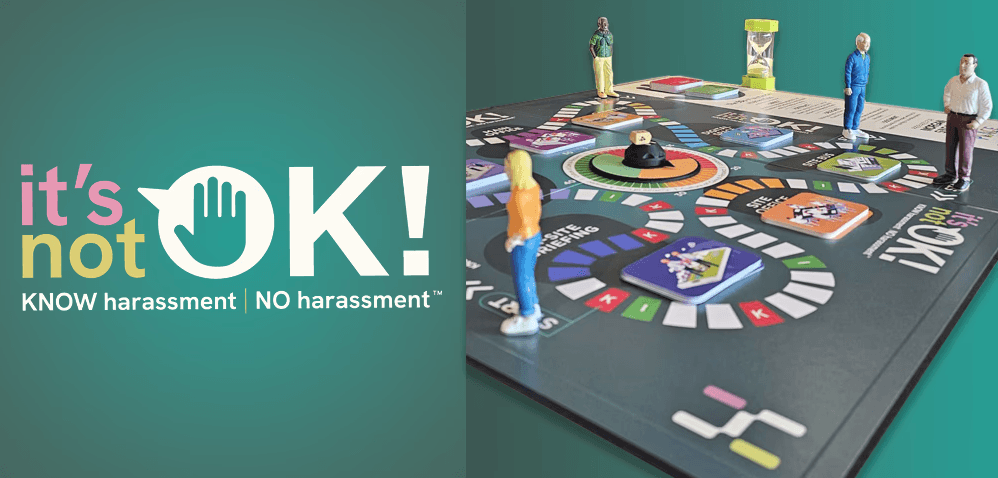 A workplace harassment prevention training board game with miniature figures positioned on a colorful circular game board, alongside the "it's not OK!" logo featuring a stop hand symbol with the tagline "KNOW harassment | NO harassment" on a teal background.