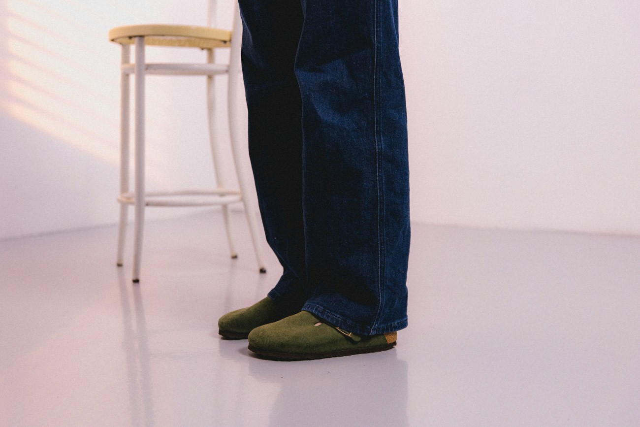 Nice denim jeans with classy shoes on a concrete floor in a white room