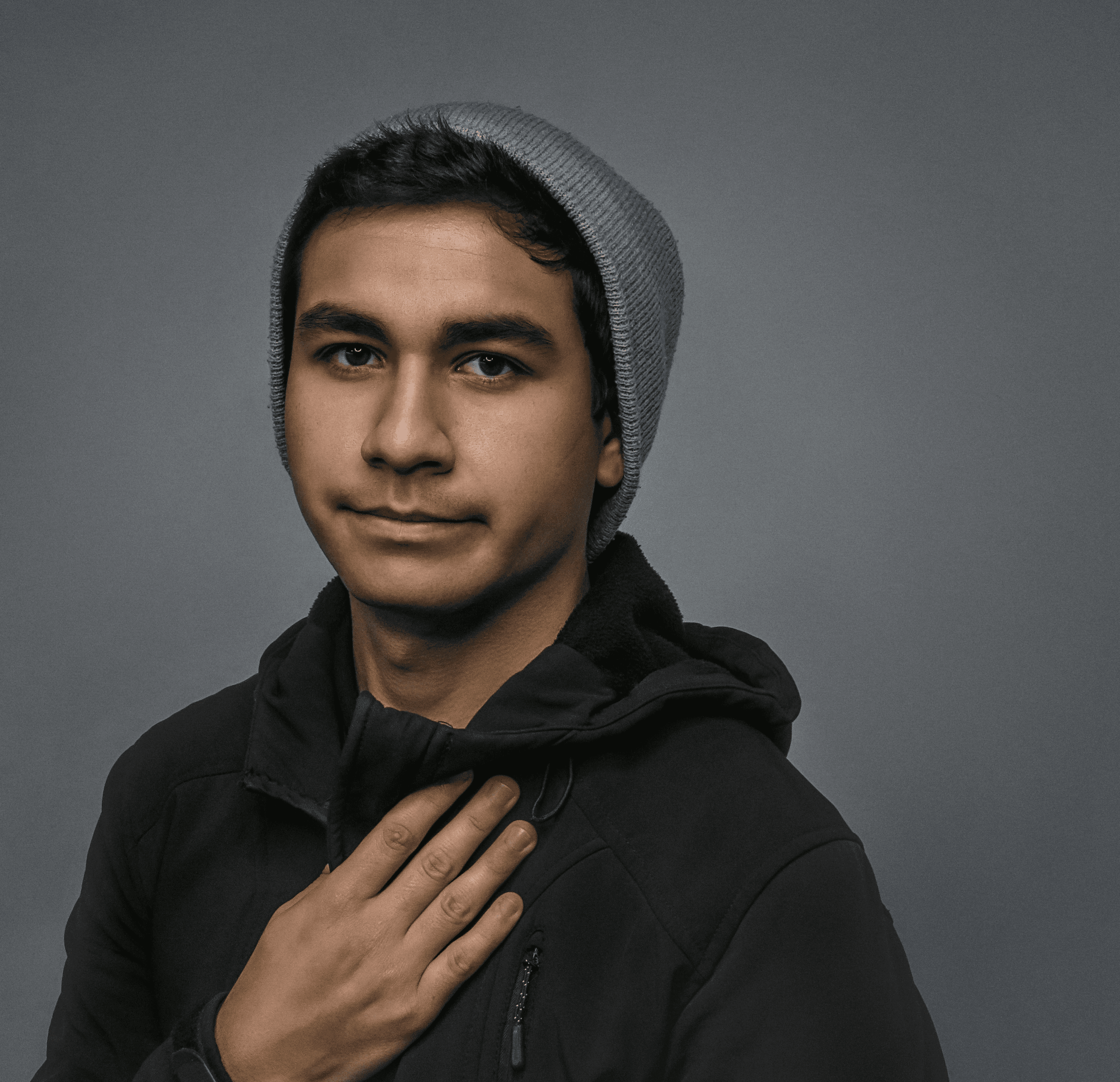 man in black hoodie and gray knit cap