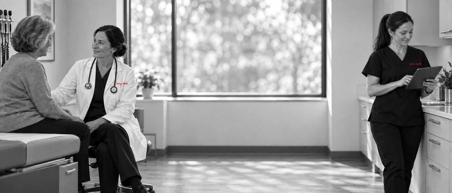 Physician talking with an older patient while a research coordinator works nearby