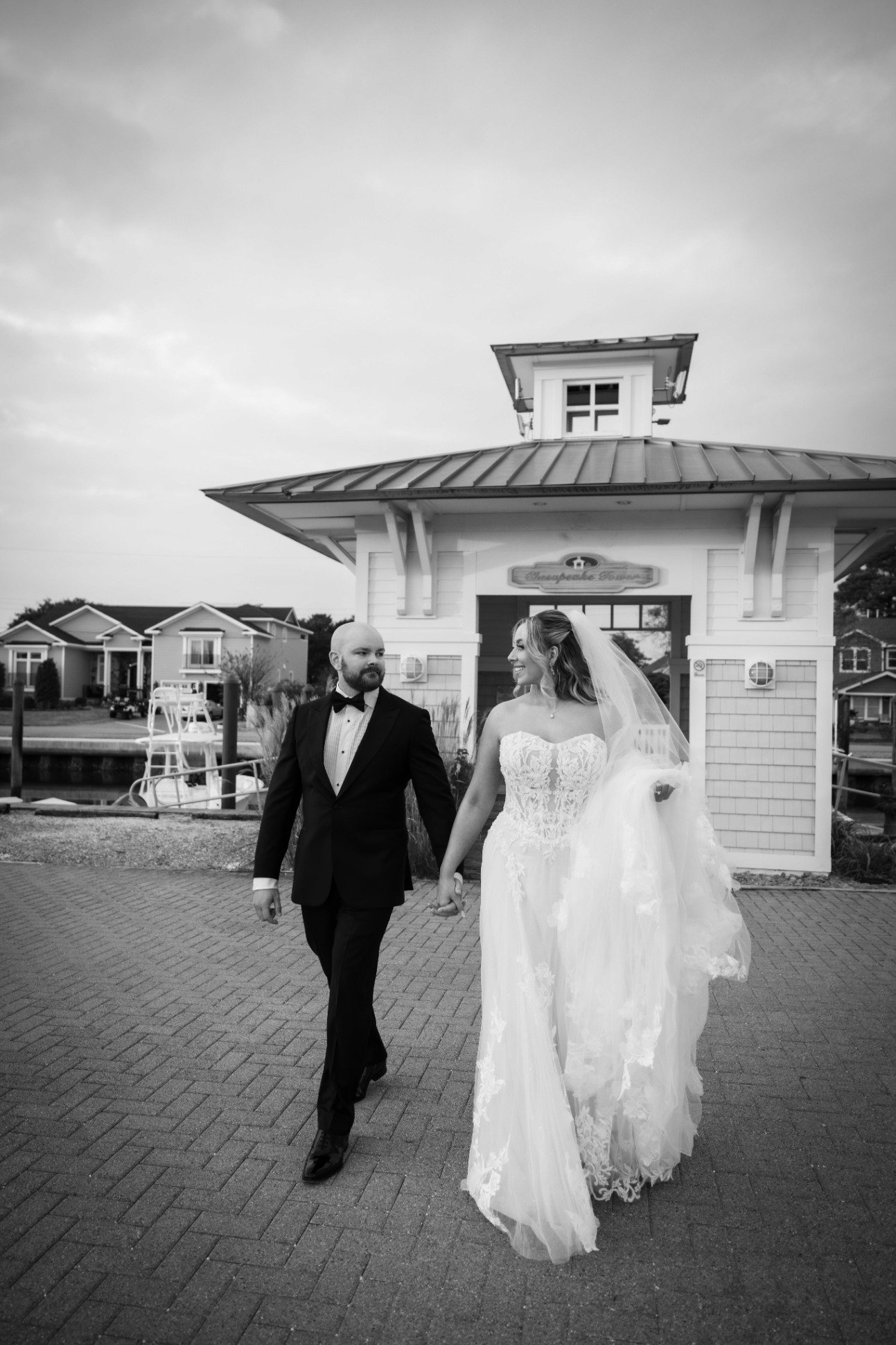 A couple stands closely in an intimate embrace.