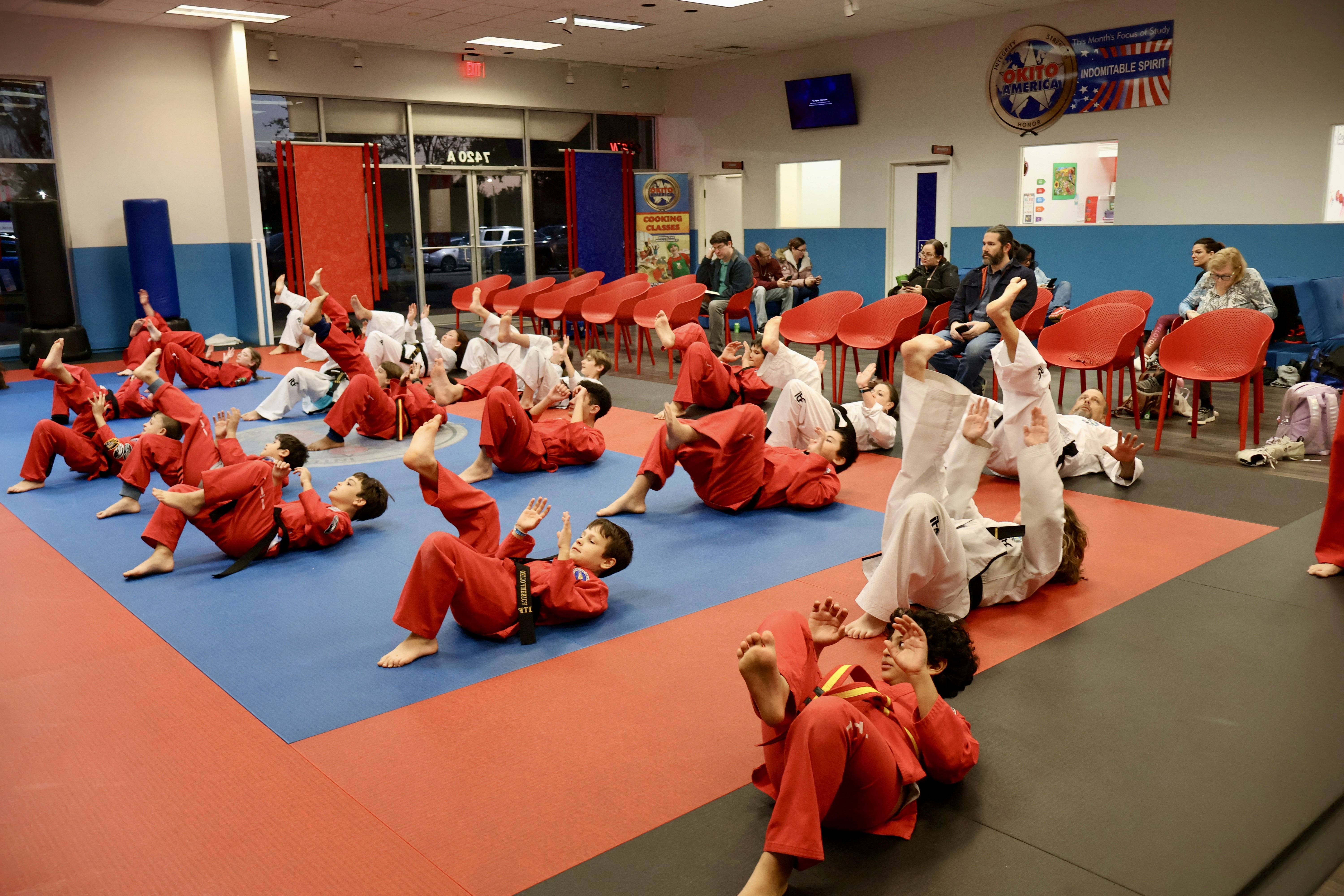 Students in class practicing an on the ground kick