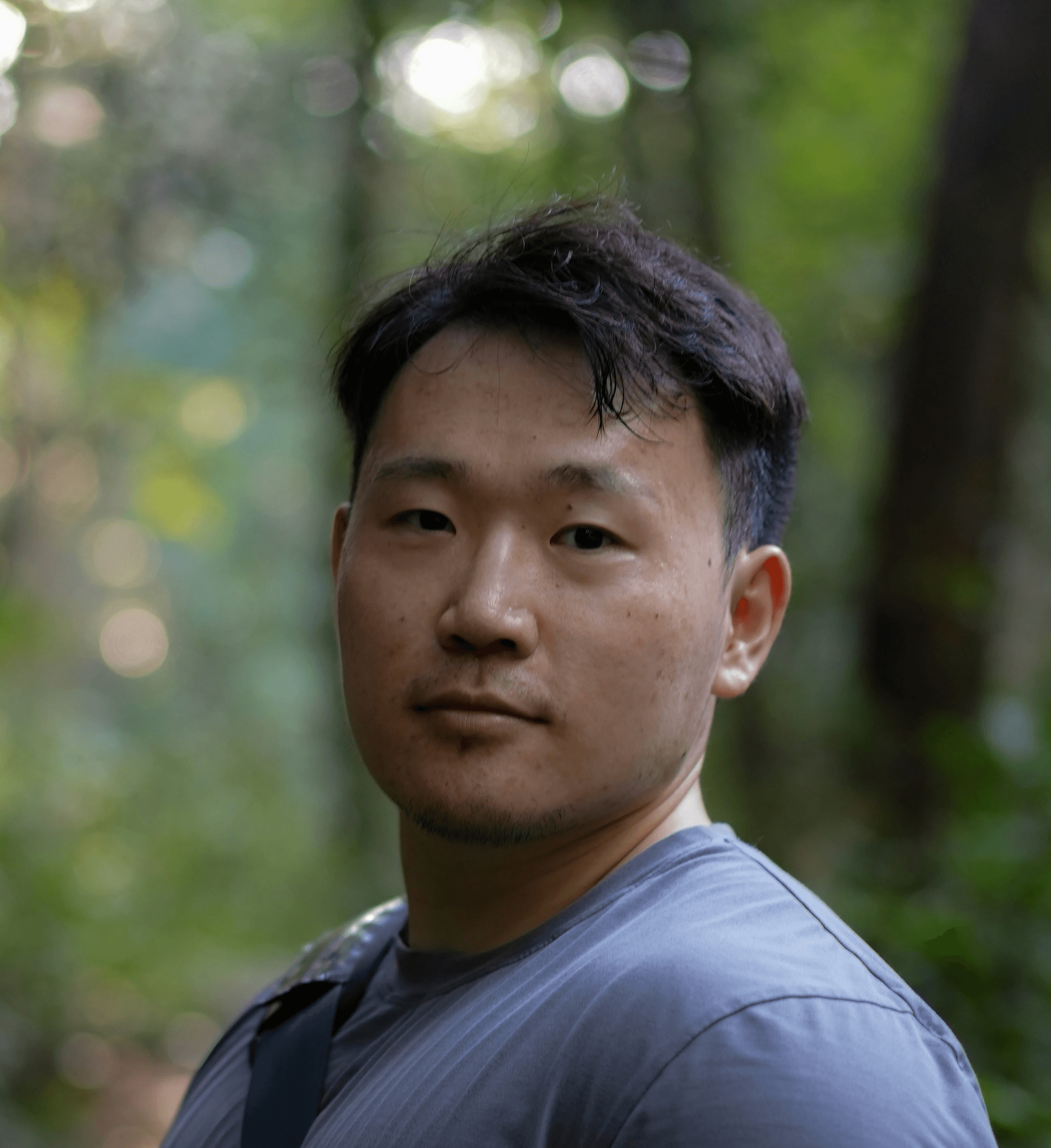 a man with a backpack standing in the woods