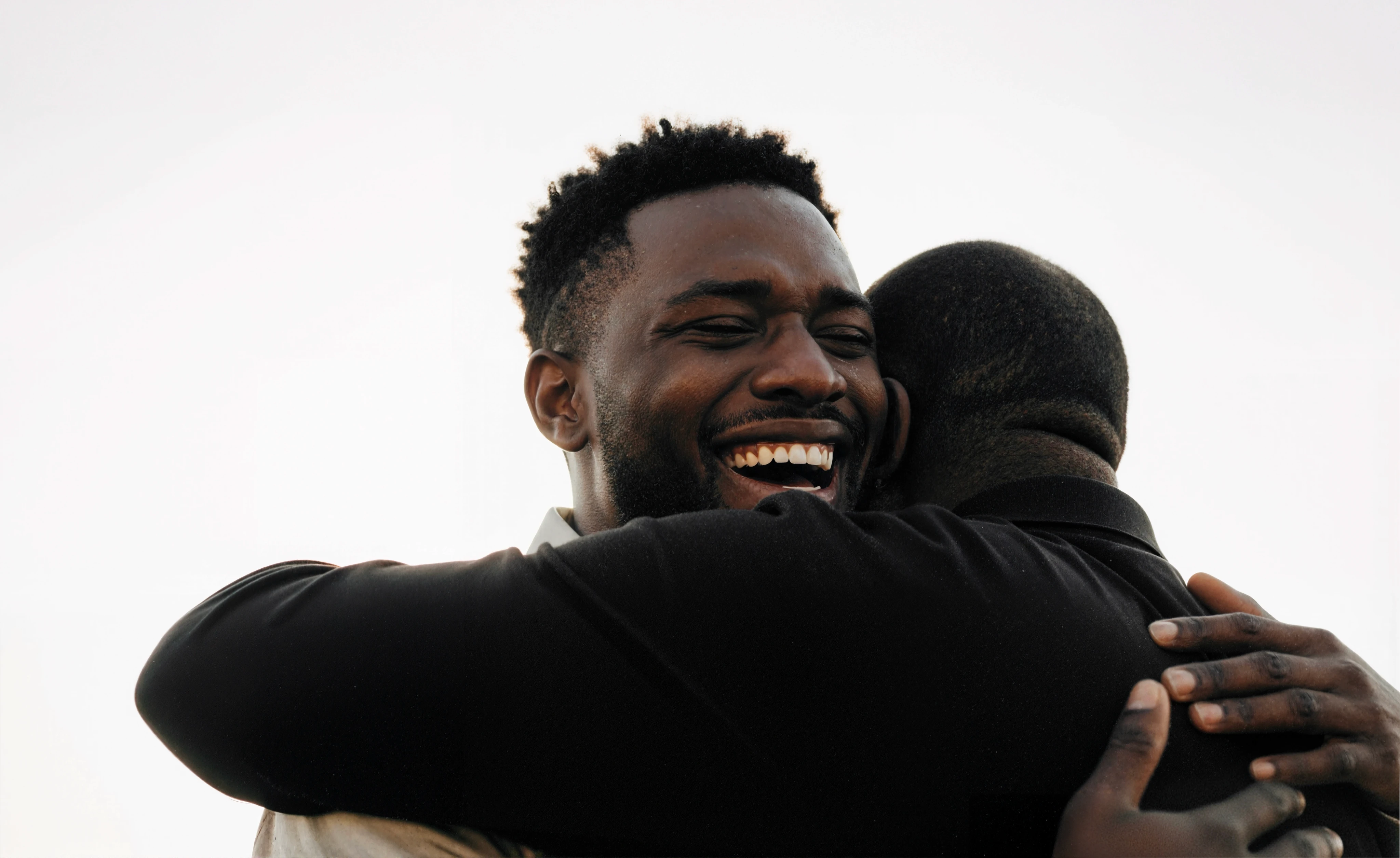 Individual celebrating recovery milestone with family support after JWHope intervention services