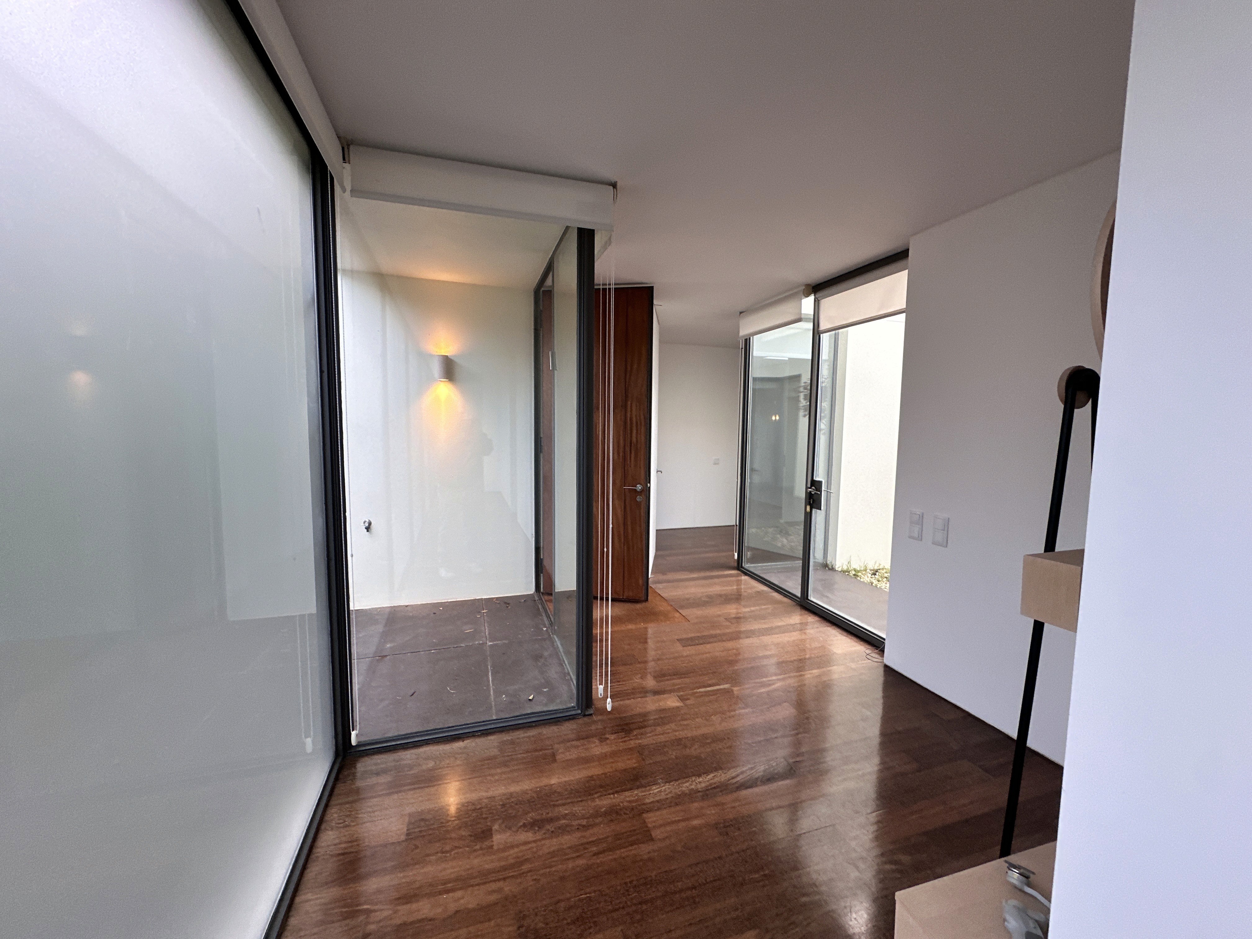 House with solar panels surrounded by forested hills