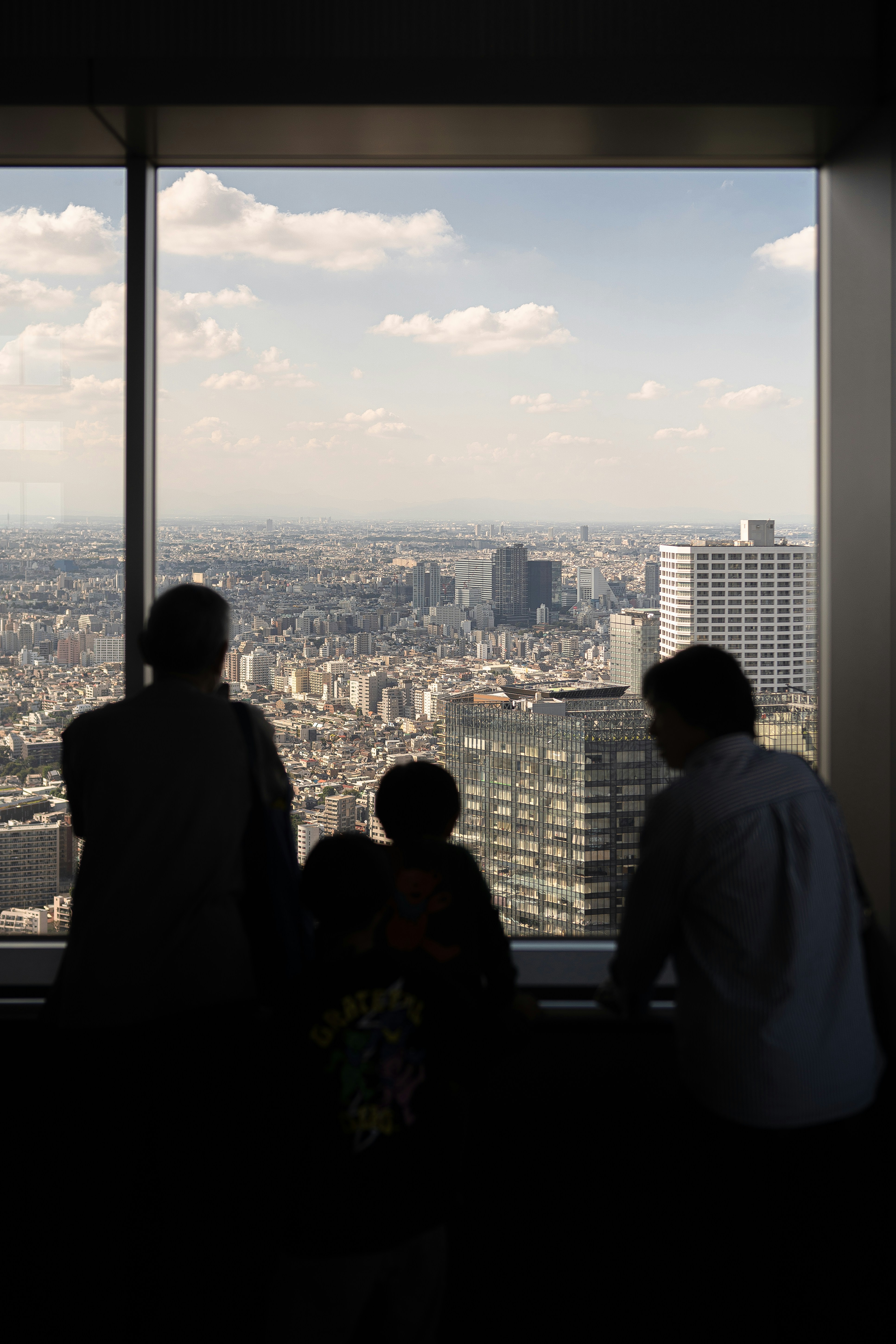 Three people looking outside at the view of our office.