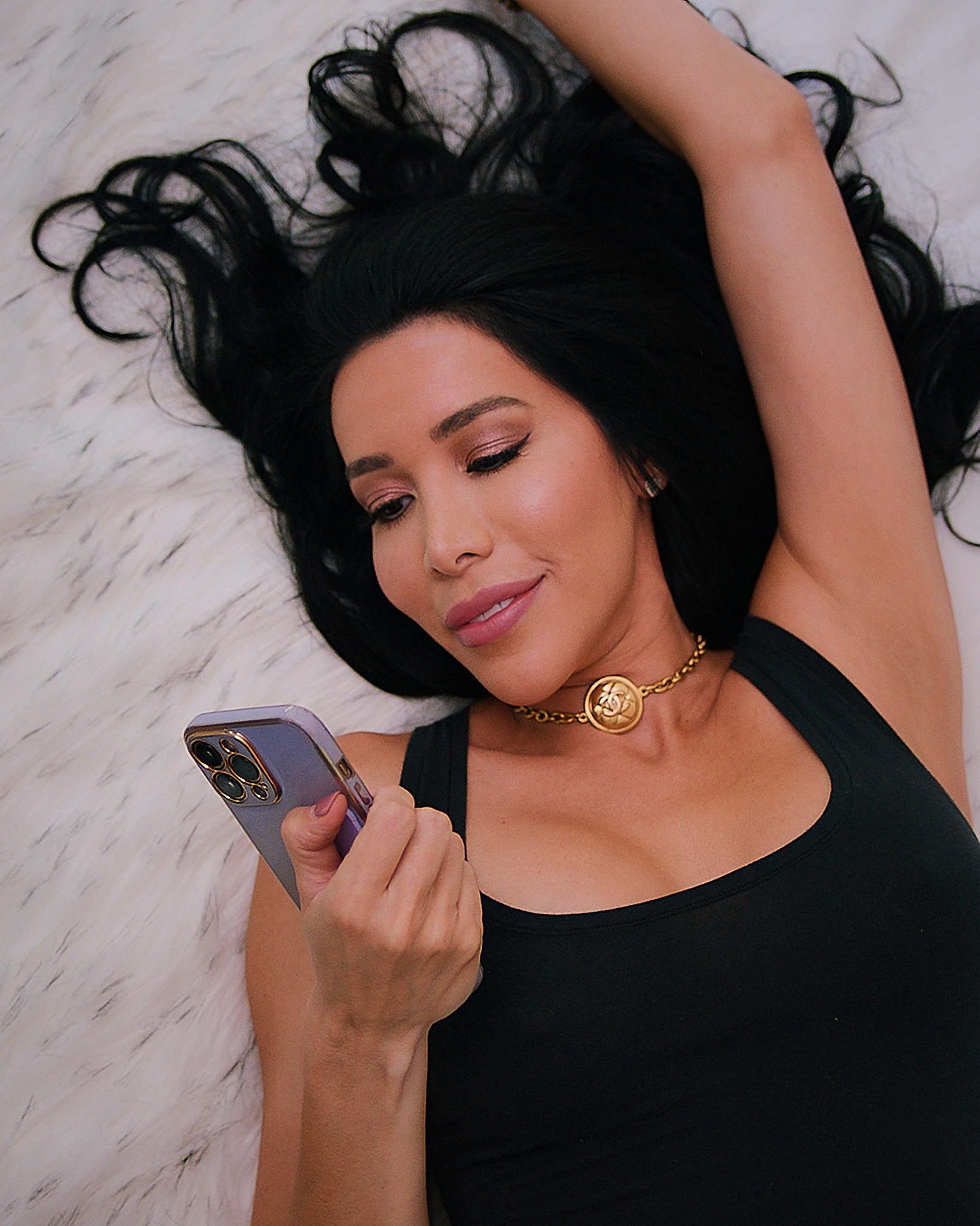 Two hands in an elegant gesture, one above the other, against a dark background