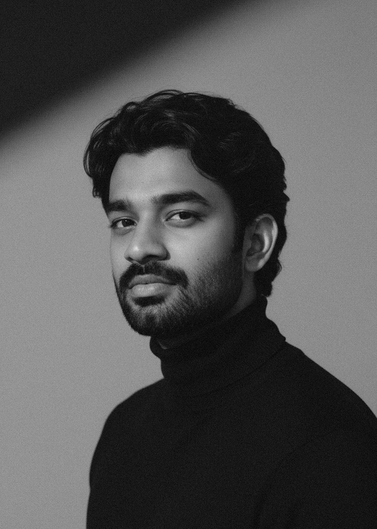 a blurry photo of a person standing in front of a wall