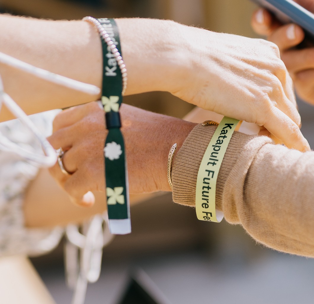 Wristbands made for Katapult Future Fest being placed on a participant's wrist.