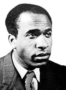 A black-and-white portrait of a man with a serious expression, short curly hair, and wearing a suit with a striped tie. His gaze is directed slightly to the side, giving a contemplative and dignified look. The photo has a classic, formal style, highlighting his composed and thoughtful demeanor.