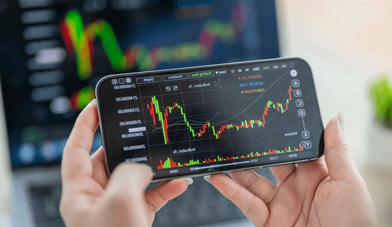 Person holding smartphone showing stock charts - Pi Network Tokenomics