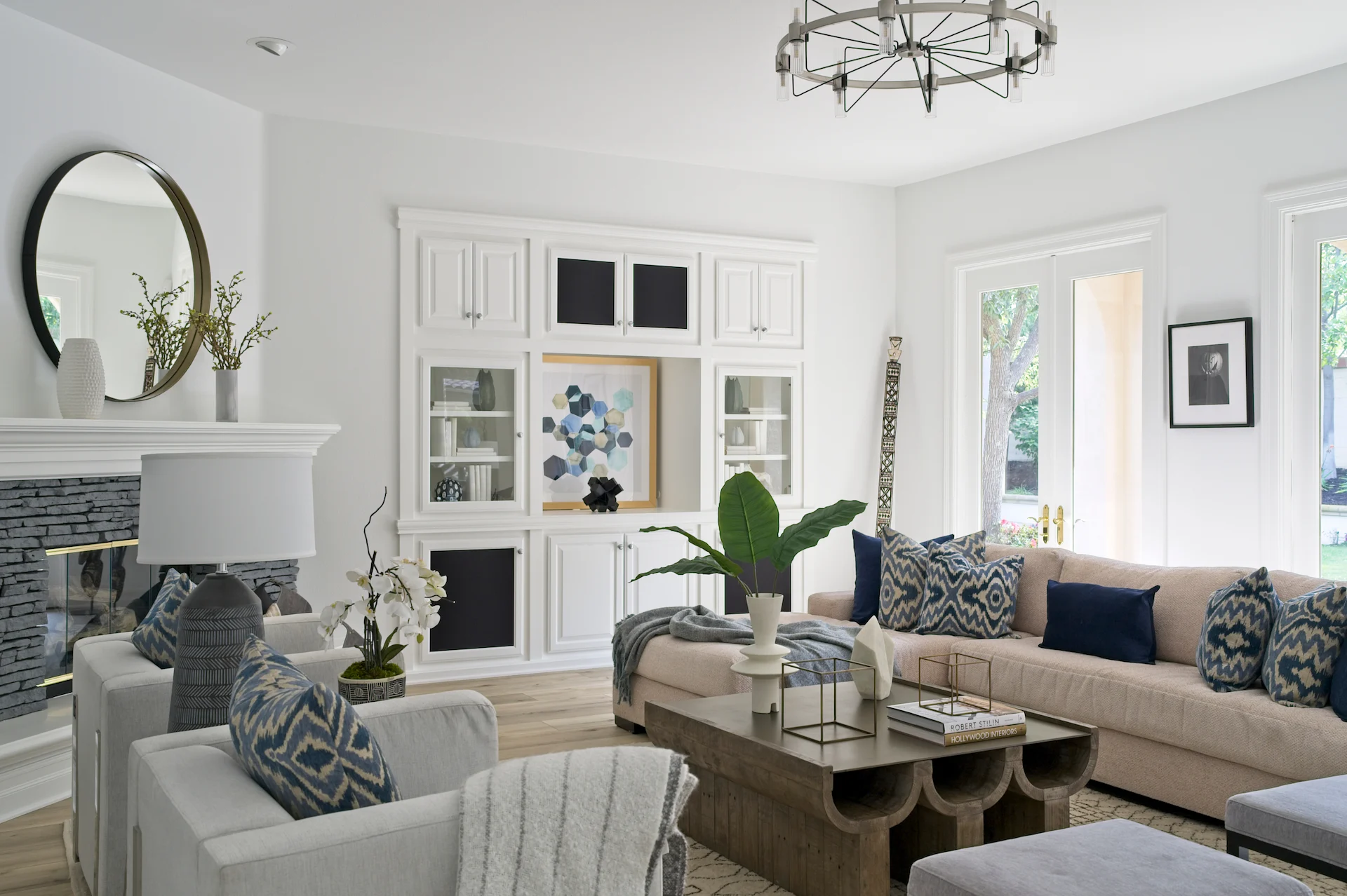 Full view of the living room from angle 2, featuring boho furniture and decor with a view of the backyard through French doors, blending indoor comfort with outdoor beauty. Photo by Todd Huge.