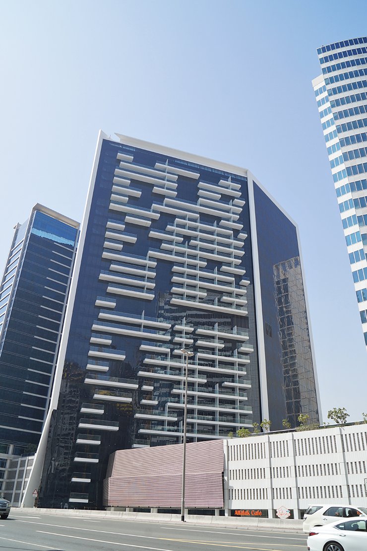 Marquise Square Tower's modern facade in Business Bay. Our agents offer expert guidance on premium Dubai properties.
