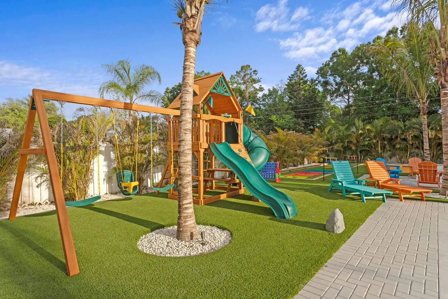 Wooden playset with swings and slide at Private Backyard Resort, Bradenton, Florida