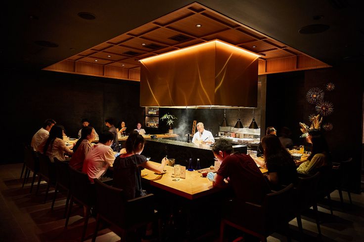 A vintage-style bar with classic wooden furnishings and ambient lighting.