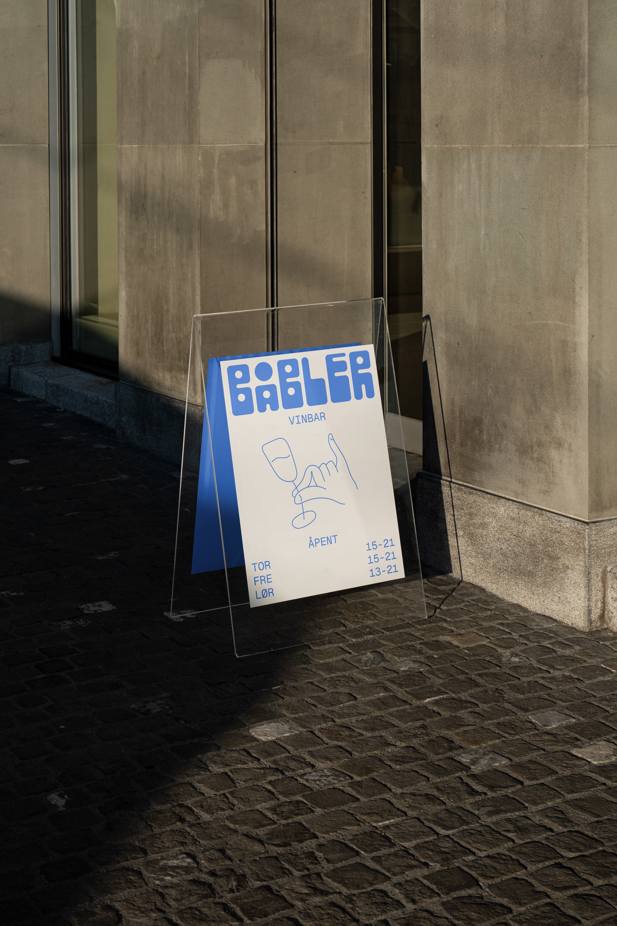 A standing sign designed for Båbler wine bar featuring it's logo, an illustration and info.