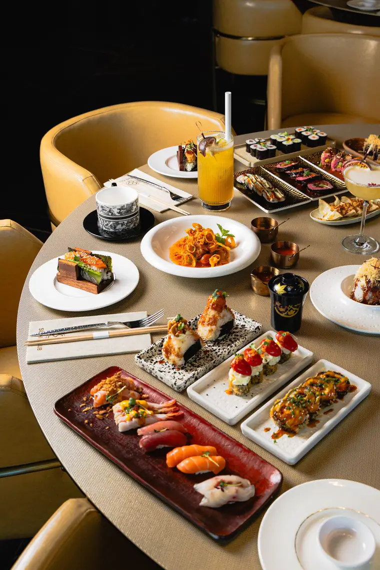 Table set with sushi, maki and cocktails at Sushi Club