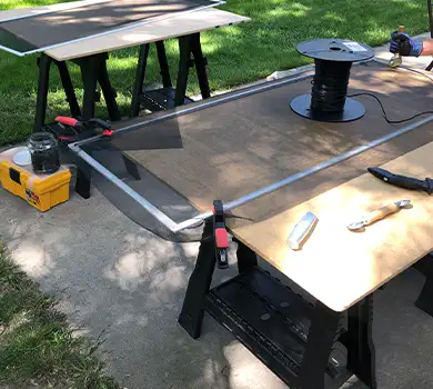 Window screen frame and spline on a workbench, showing our screen assembly process.