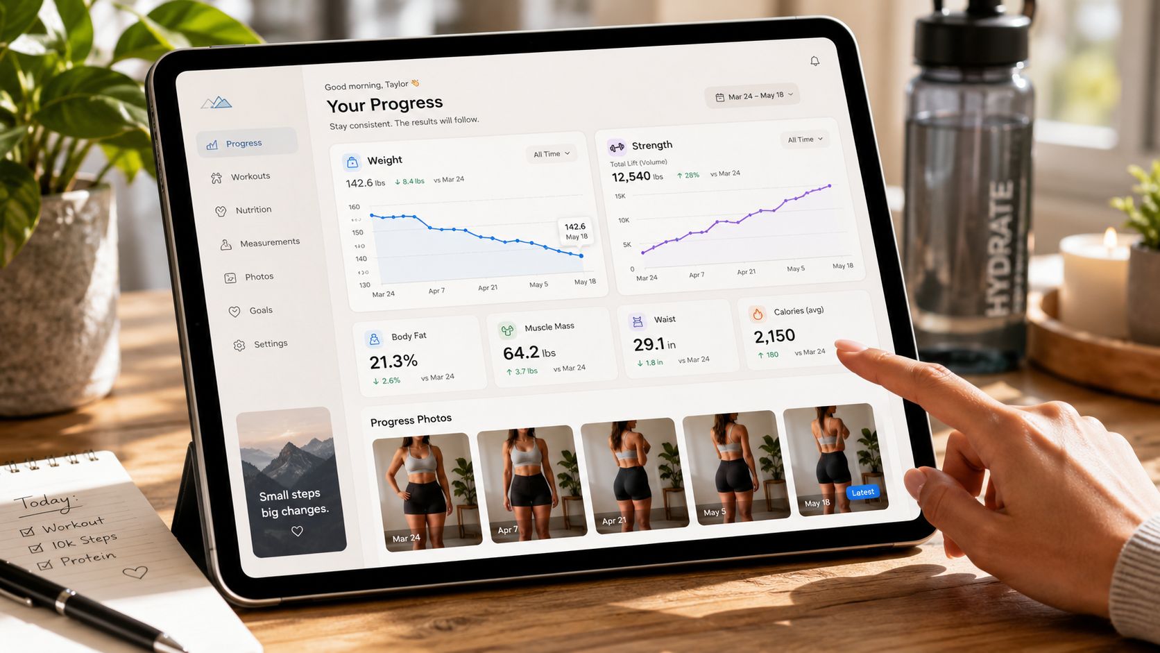 A person using a tablet displaying a fitness progress tracking app with health charts and photos.