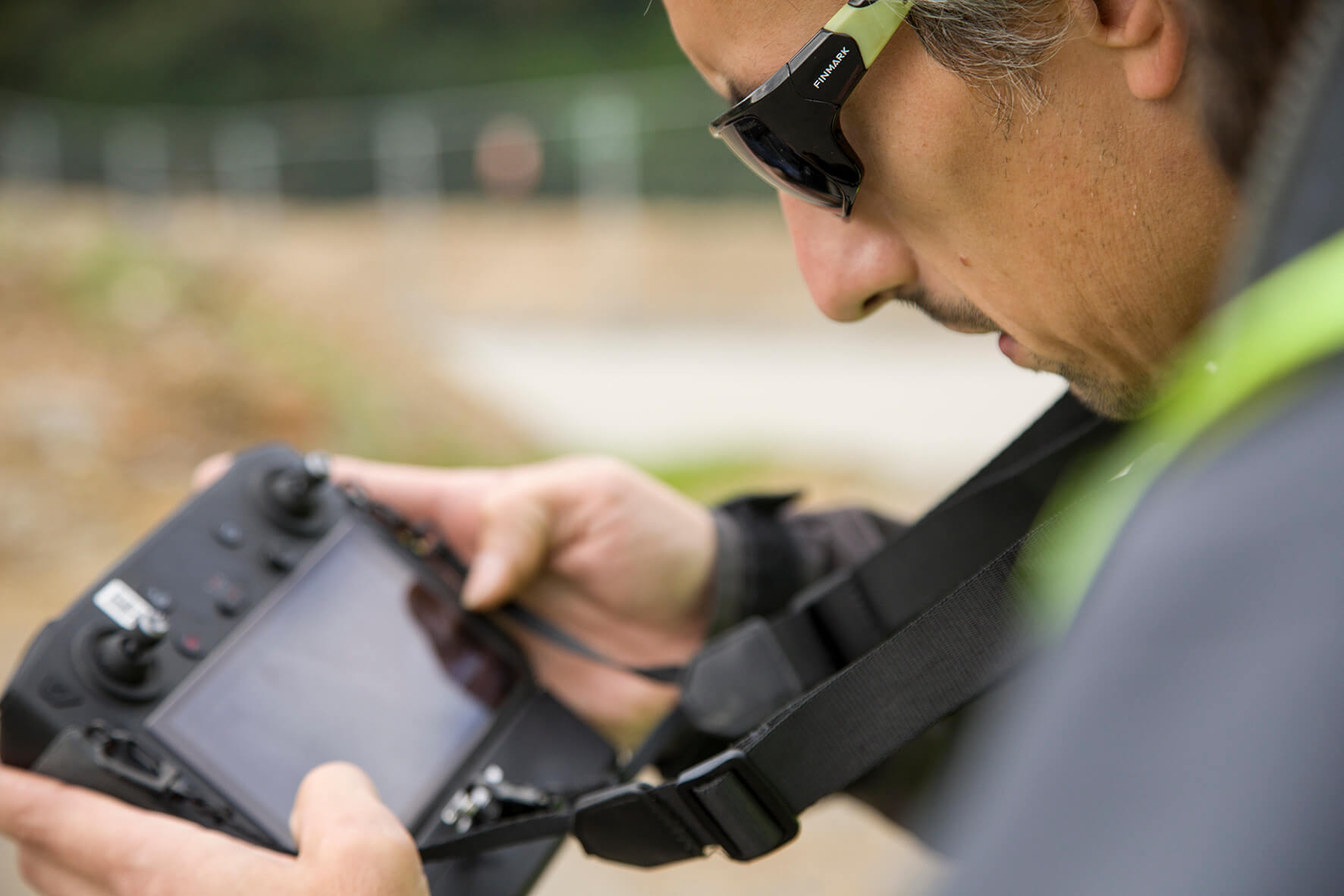 A drone service provider operating a drone on site