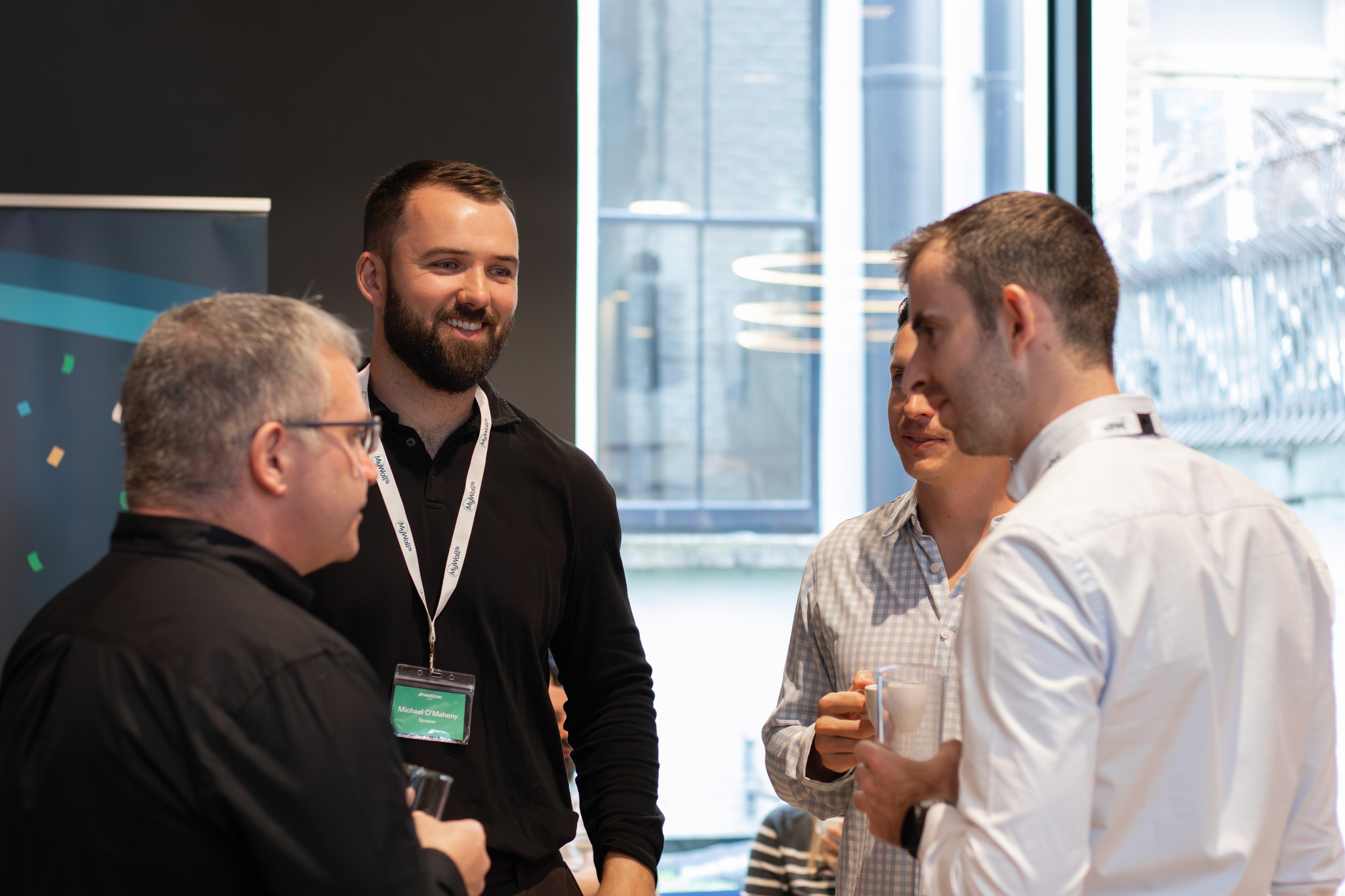 Three professionals engage in a lively conversation at a networking event, illustrating the valuable connections and opportunities for growth available at Investicon. Join industry leaders and fellow investors in stocks, AI, and whiskey at the historic Irish Stock Exchange. #Investicon #NetworkingOpportunity #BusinessConnections #InvestmentCommunity #DublinEvents