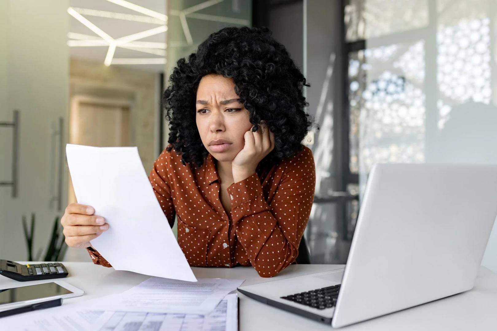 Upset and unsatisfied woman at workplace businesswoman boss checking documents accounts and