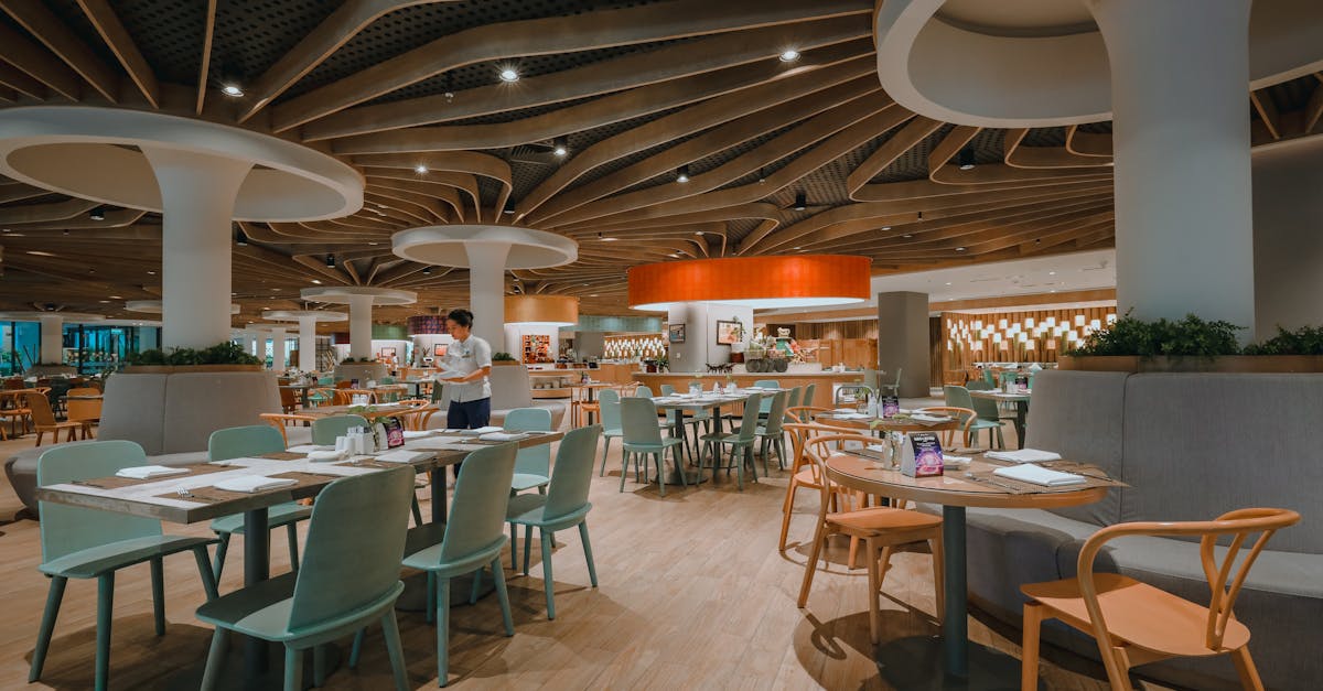 Contemporary restaurant interior showcasing elegant furniture and unique ceiling design.