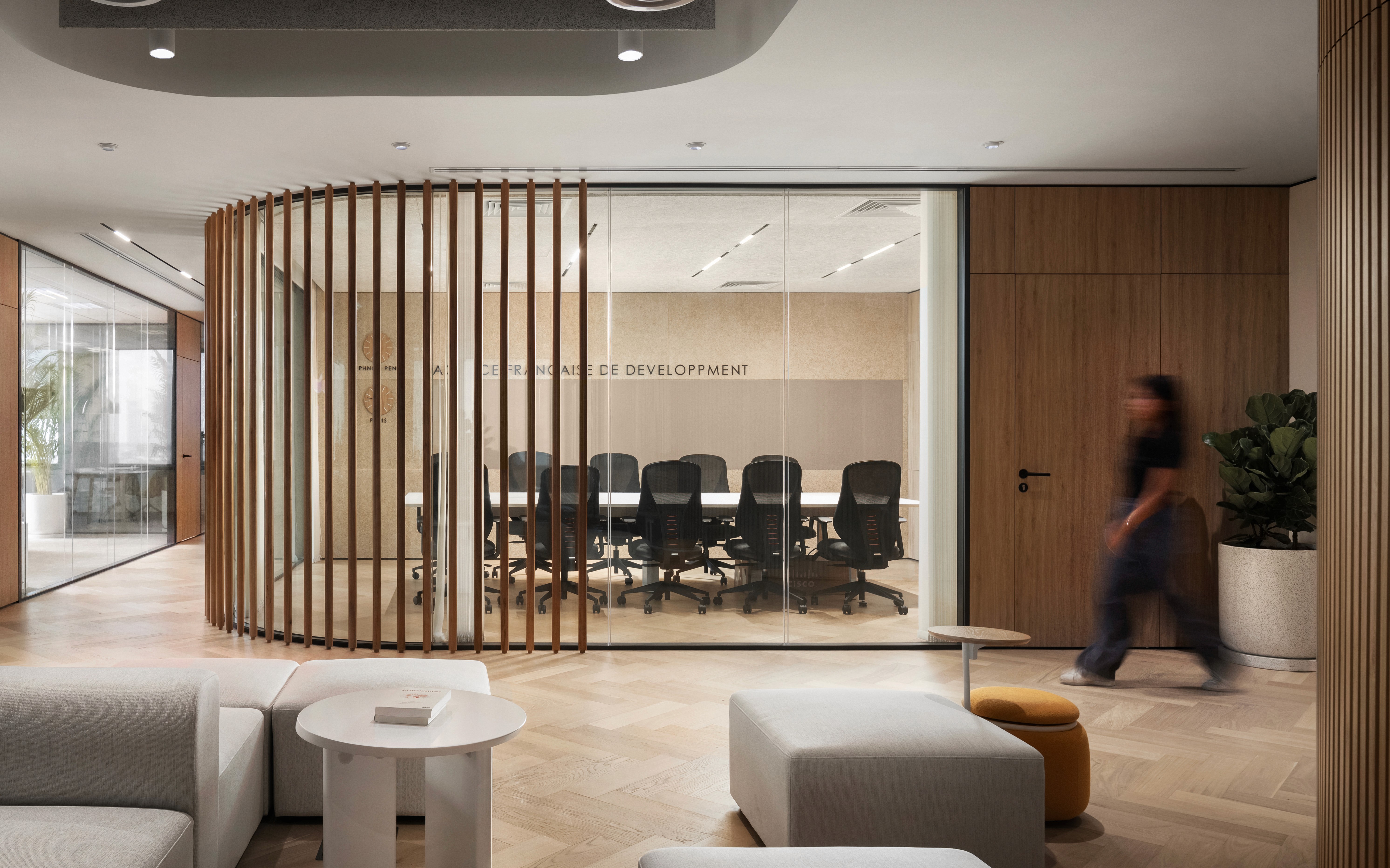 Formal meeting room at the AFD office in Phnom Penh illustrating a deliberate spatial hierarchy and high-quality materiality that communicates institutional brand identity