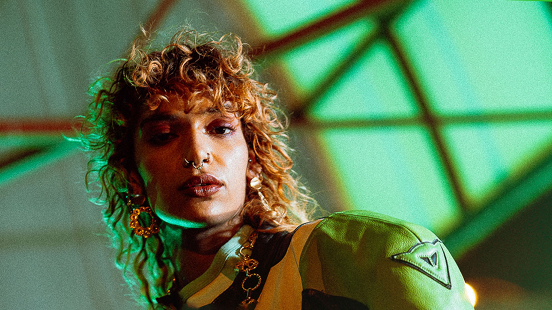 Woman wears a blue coat in a blue environment.