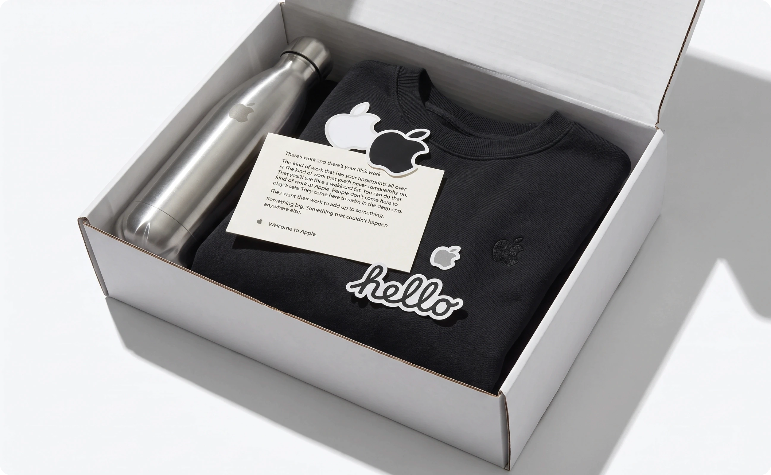 A swag kit containing a tote bag, a blue hoodie, a gray notebook, and a Stanley tumbler.