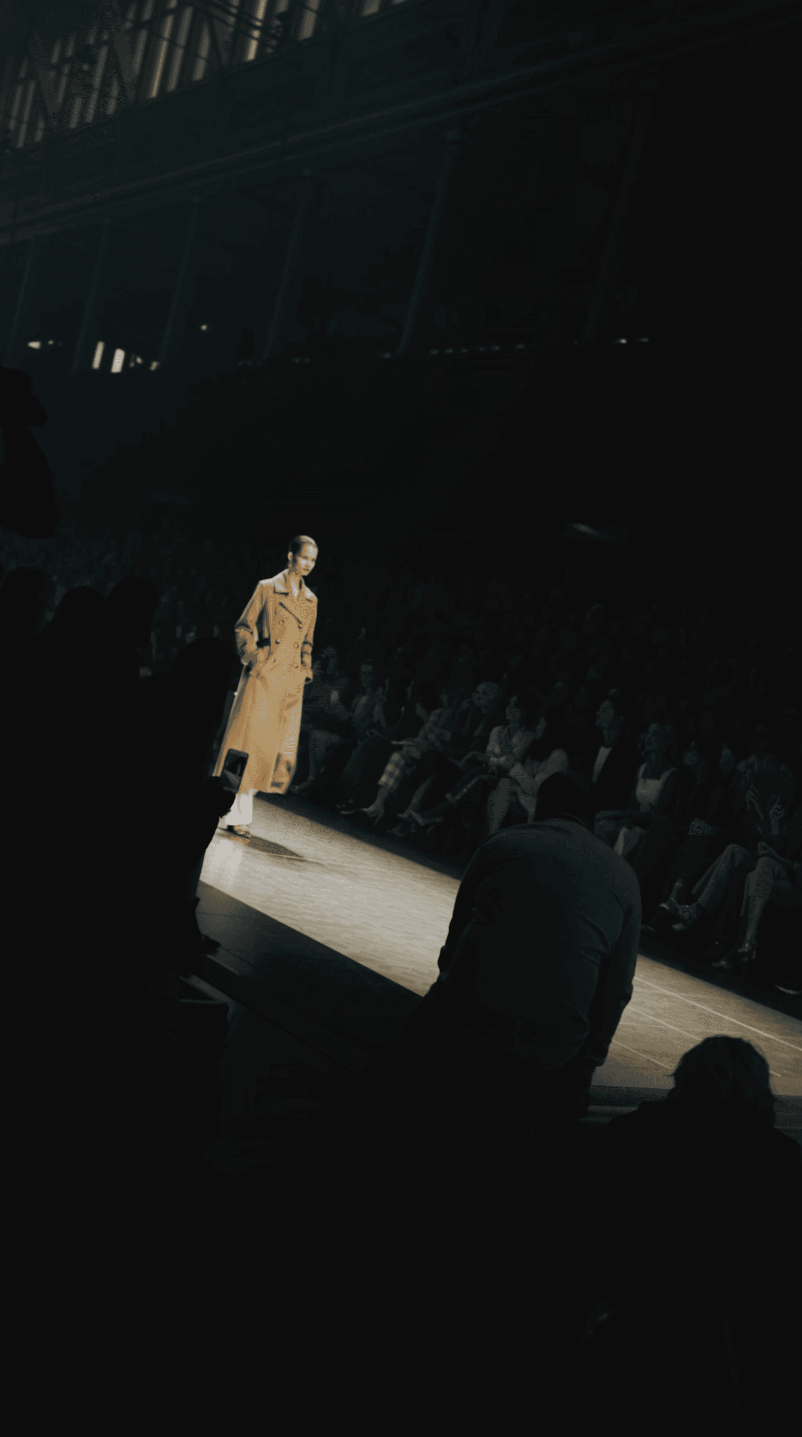 Close-up of a hand holding a lit match against a dark background
