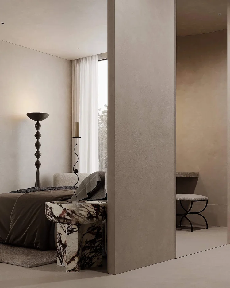 Minimalist bedroom design with beige walls, cozy bed, and unique marble side table.