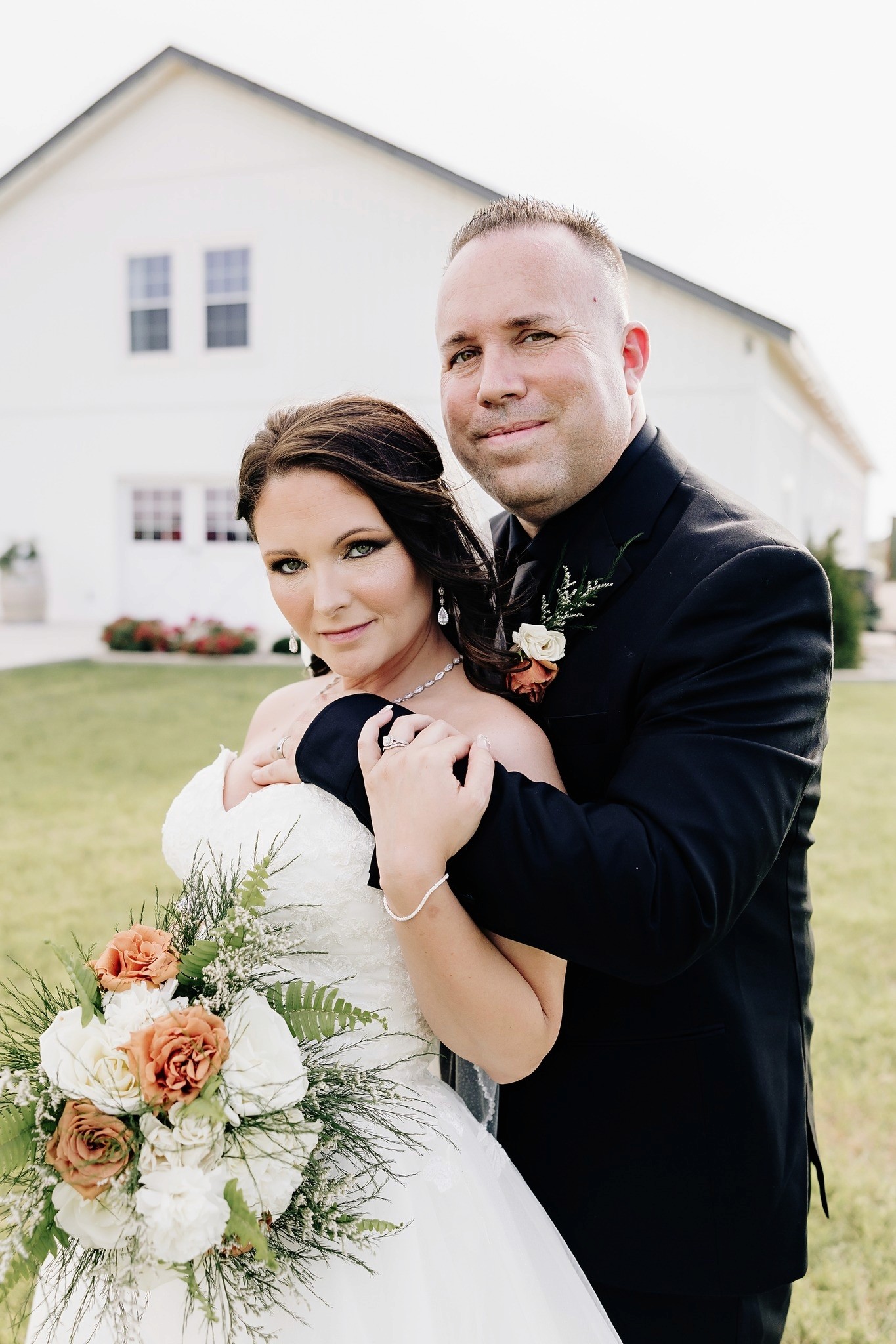 A person with short blonde hair holds a vintage camera.