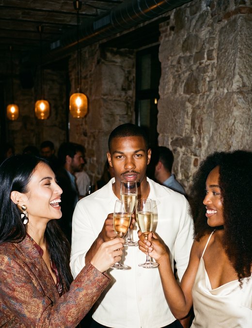Three friends toasting with champagne