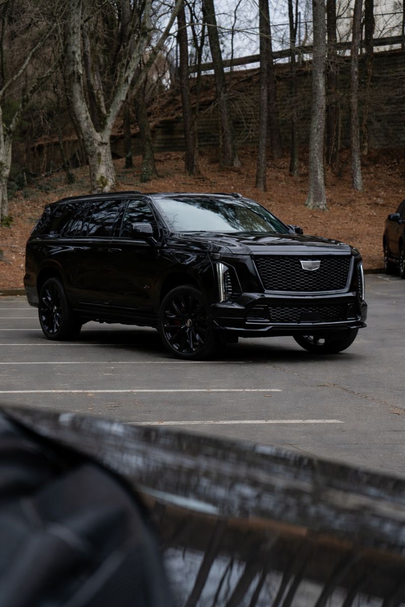 A shirtless man flexing outdoors next to gym equipment, pointing upward. Text: Ethan Brooks – Strength Coach.