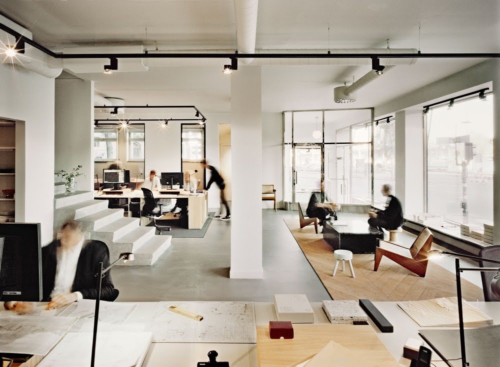 Bright, modern office with a variety of workspaces that encourage collaboration and communication. 