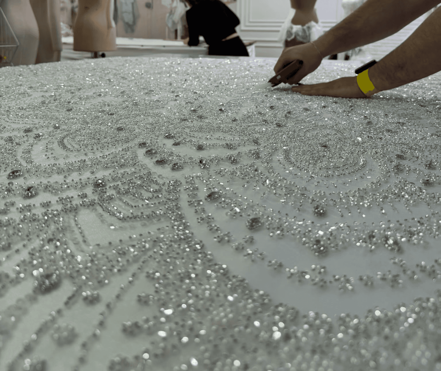 Lucidbride atelier crafting a beaded lace custom wedding gown.