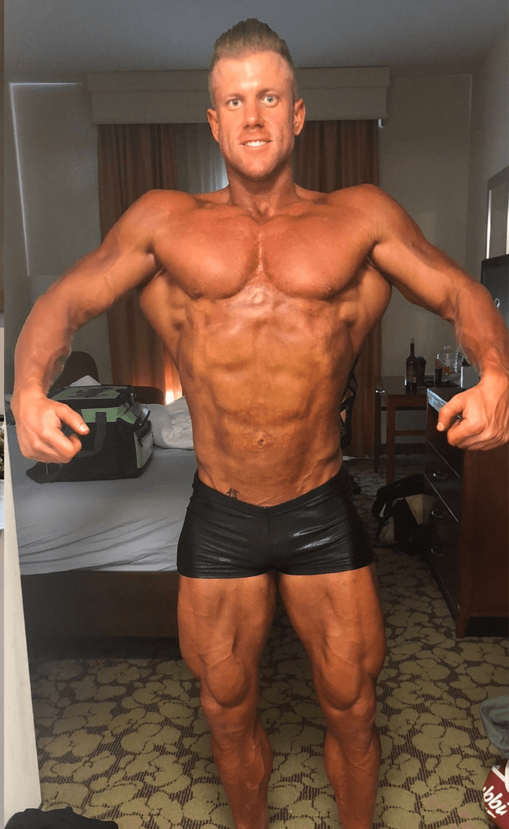Corey Hartley after significant fat loss and bodybuilding show prep through online coaching