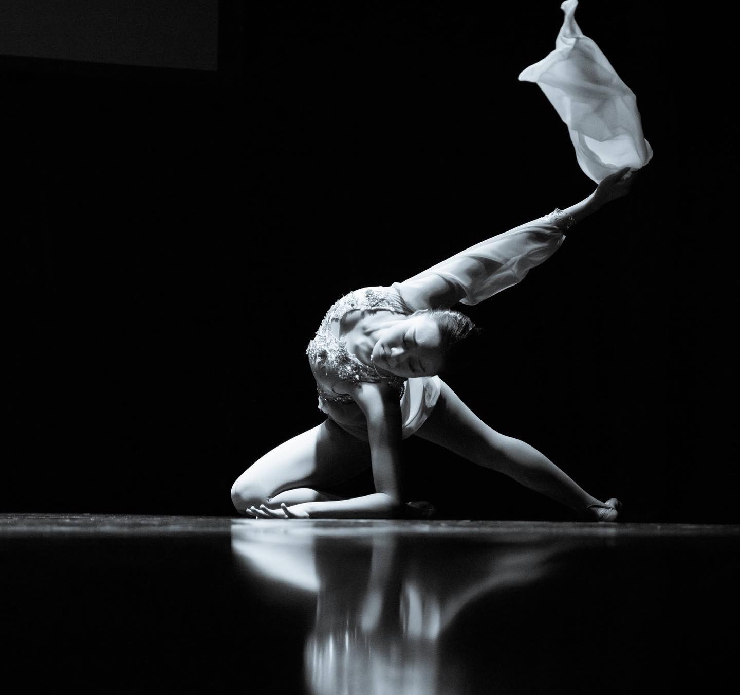 Smiling woman holding olive cocktail.