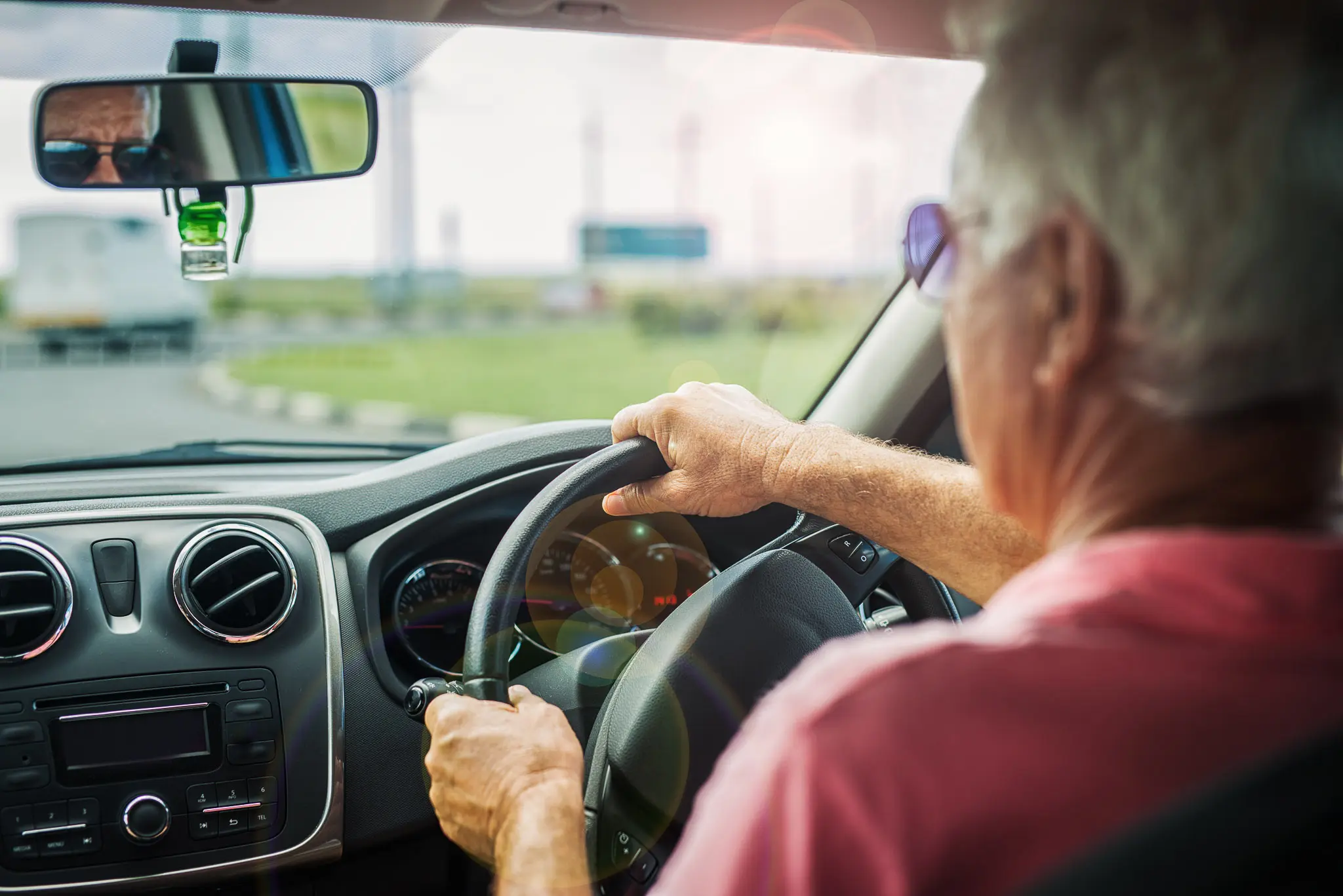 Older driver behind the wheel of a vehicle