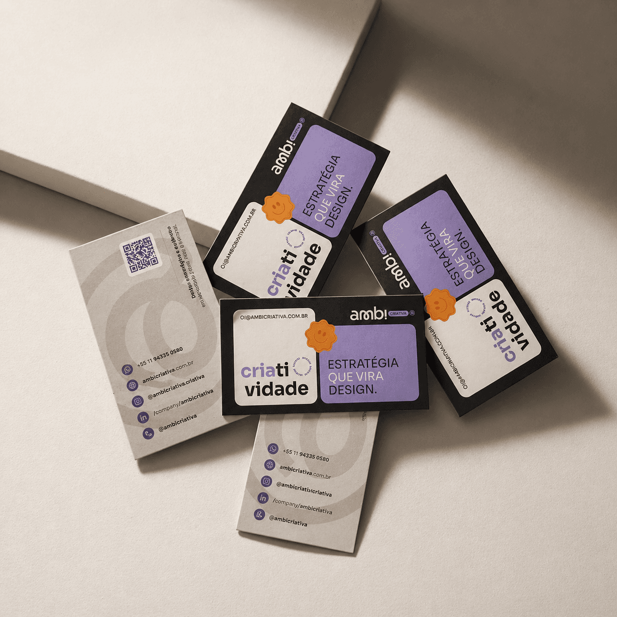Several business cards with brand "Ambi Criativa" and "Nascemos para transformar ideias" slogans.
