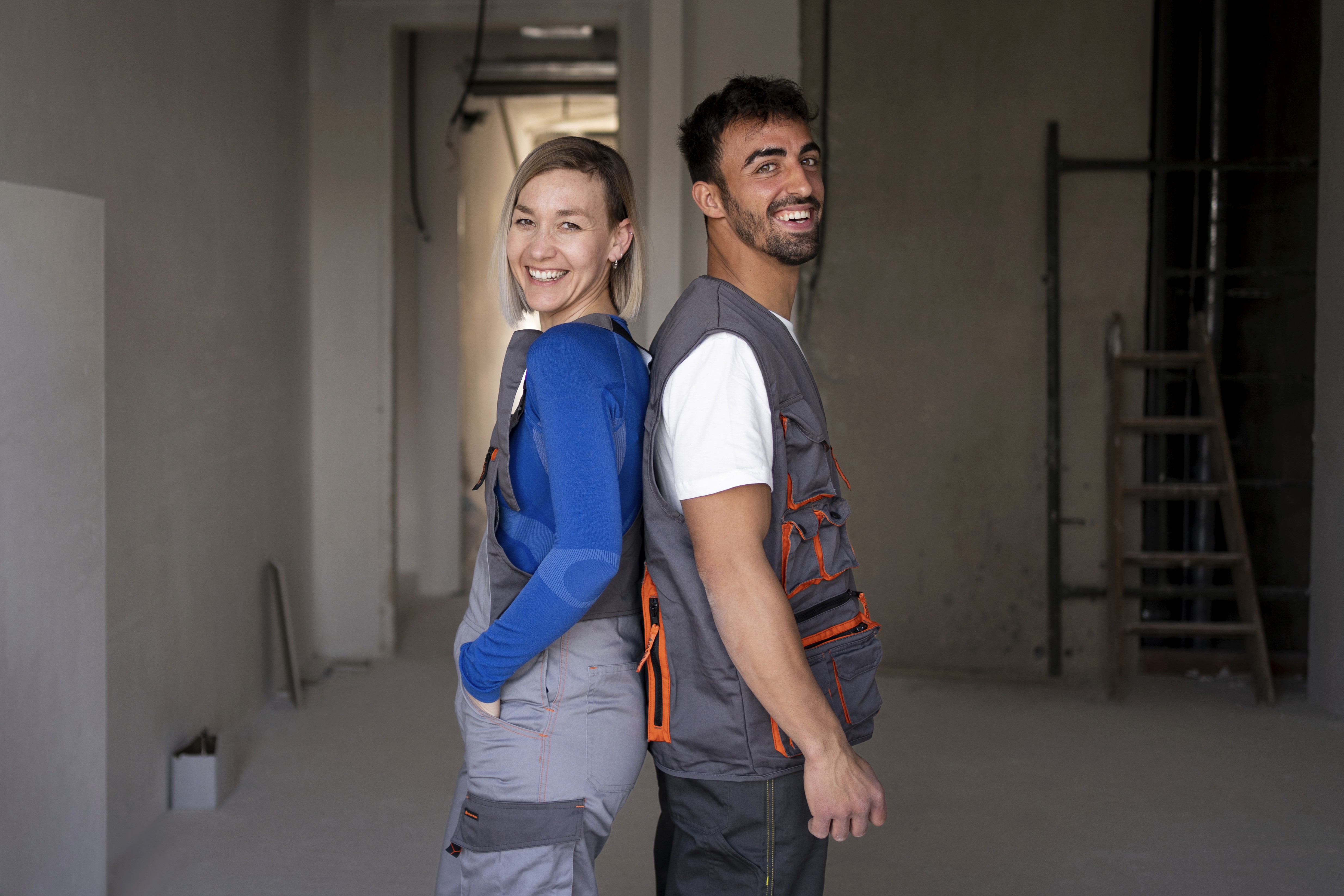 A group of six people poses on a city street, with buildings and shops visible in the background.