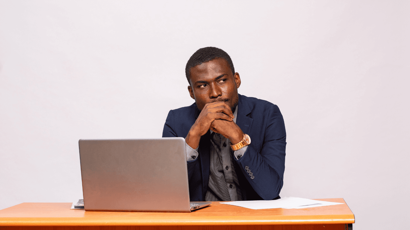 A luxurious bathtub filled with water and floating rose petals, surrounded by candles and greenery. The soft lighting creates a tranquil and romantic spa-like atmosphere.