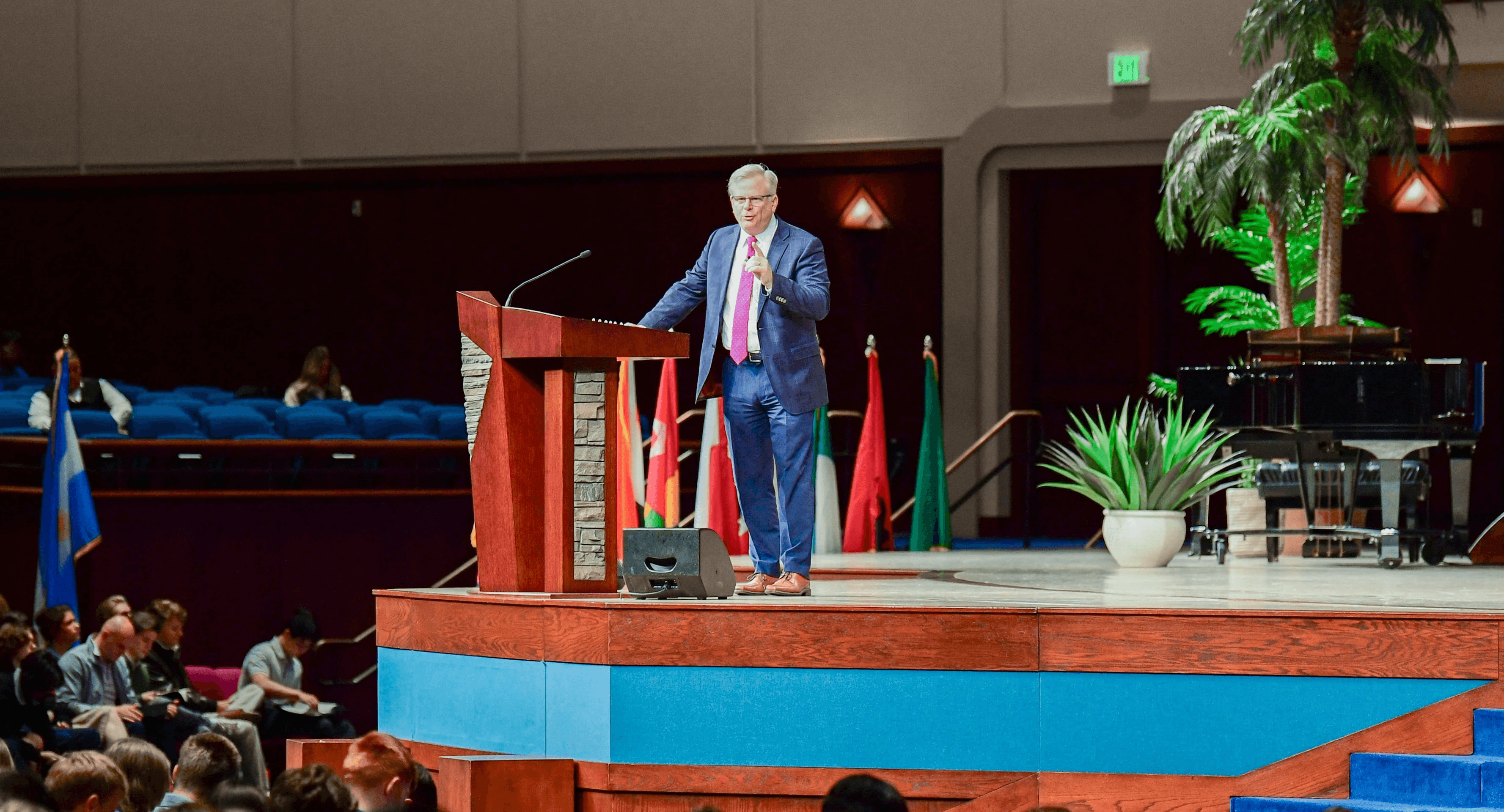 A fast black sports car races down the highway.