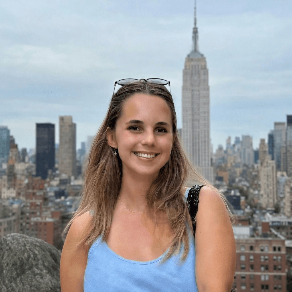 smiling woman wearing blue necklace